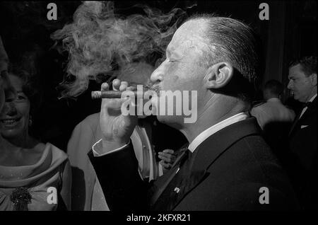 Juan Carlos Onganía, Argentine defacto president, smokes a cigar at a reception in the Brazilian embassy in Buenos Aires, 1967 Stock Photo