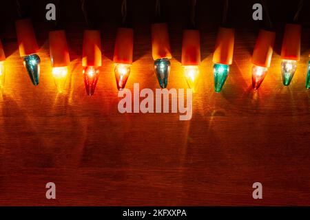 Christmas Lights - Retro light bulbs on wooden background with copy space Stock Photo