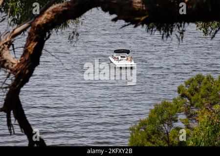 Small group of people relaxing in a boat,Paynesville, Victoria, Australia Stock Photo