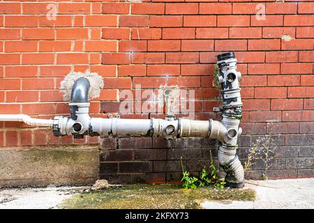 Old and damaged pipework of commercial building Stock Photo