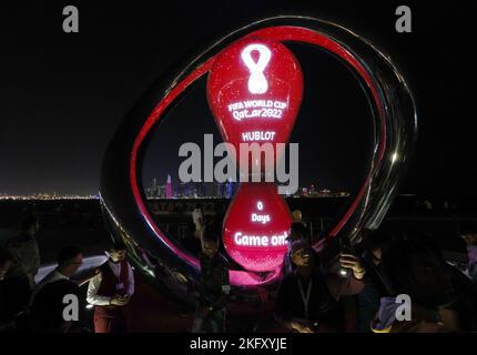 Doha, Qatar. 20th Nov, 2022. People pose with the FIFA World Cup 2022 countdown clock at Al Bidda park in Doha, Qatar, Nov. 20, 2022. Credit: Meng Yongmin/Xinhua/Alamy Live News Stock Photo