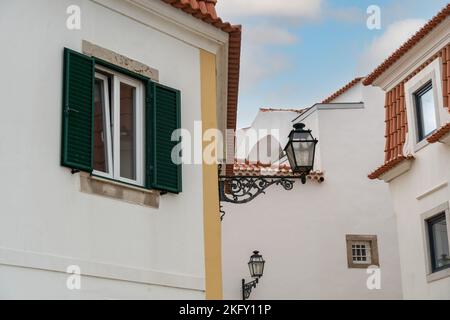 Mediterranean house with green louvered window and shutters. traditional town street with vintage buildings Stock Photo