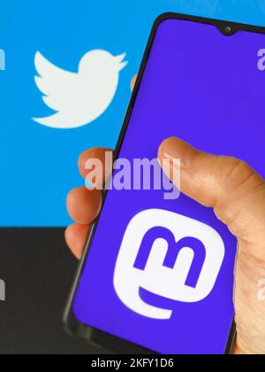 Mastodon alternative social media service on a smartphone screen with Twitter logo shown in the background. Stock Photo