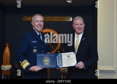 Vice Adm. Kevin Lunday, U.S. Coast Guard Atlantic Area commander, holds a certificate of recognition with retired Army Maj. Gen. Peter Aylward, director of The United States of America Vietnam War Commemoration in Portsmouth, Virginia, Oct. 14, 2022. The VWC program awarded the certificate in recognition of Coast Guard Atlantic Area becoming a commemorative partner of the organization. Stock Photo
