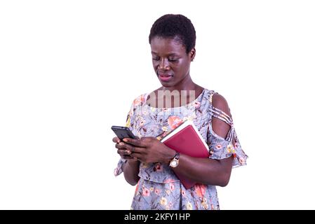 portrait of beautiful young serious female student using a mobile phone. Stock Photo