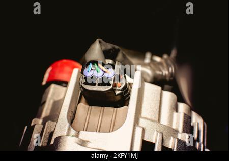 Electric plug wire connected to alternator with three wires type of the vehicle electric system Stock Photo