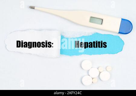 Medical diagnosis. A gap is made in the middle of the white sheet, inside of which there is an inscription - Hepatitis on a blue background. On the sh Stock Photo