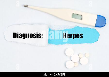 Medical diagnosis. A gap is made in the middle of the white sheet, inside of which there is an inscription - Herpes on a blue background. On the sheet Stock Photo