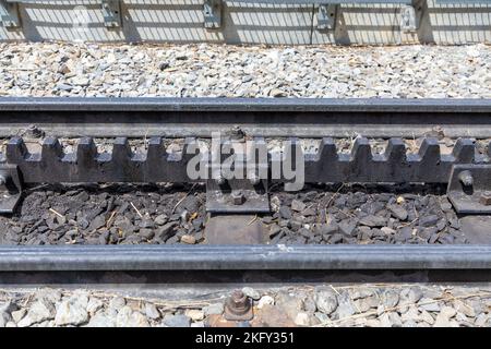 Train tracks with a cog system in the middle of the tracks. Typical of train tracks in the Swiss Alps. Stock Photo