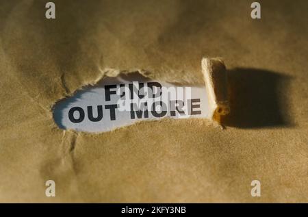 Economy and business concept. Torn paper in the middle of the sheet, inside on a white background the inscription - FIND OUT MORE Stock Photo