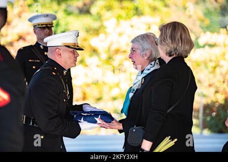 The U.S. flag is presented to Betty O'Donnell following military funeral honors with funeral escort for her husband, U.S. Marine Corps Maj. Brendan O’Donnell, in Section 83 of Arlington National Cemetery, Arlington, Va., Oct. 14, 2022.    Maj. O’Donnell entered the Marine Corps in October of 1950 and fought in the Korean War as a second lieutenant. By early April 1951, Maj. O’Donnell had become a platoon leader in Company D, 2nd Battalion of the 7th Marine Regiment, supporting the Army’s 1st Cavalry Division. His platoon was fighting to the Kansas Line, along the 38th parallel — the dividing l Stock Photo
