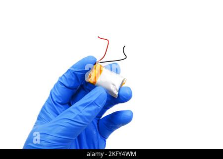 Small lithium polymer battery swollen in a hand on white background Stock Photo