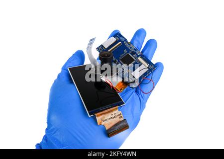 Electronics hazardous waste in a hand on white background Stock Photo