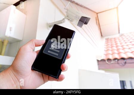 Sign in to the mobile phone app for a CCTV IP camera by own, Home security concept Stock Photo