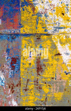 Colorful chaotic paint brush strokes on a rough old wall with a rusty abstract surface. Multicolor textured art surface Stock Photo
