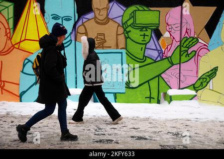 Moscow, Russia. 20th November, 2022 People walk past a graffiti by artist Misha Most at the So-yedineniye (Connection) exhibition of street art held in an art quarter near Moscow's Kursky railway station. The exhibition shows works by six artists, Roma Muratkin, Misha Most, Alexei Luka, Olya Iney, Sasha Blot, and Vova Nootk; aimed at supporting street artists, the project was developed by experts of the Moscow architecture and urban development committee and the Winzavod Center for Contemporary Stock Photo