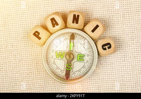 Business concept. On the table is a compass and cubes with the inscription - PANIC Stock Photo