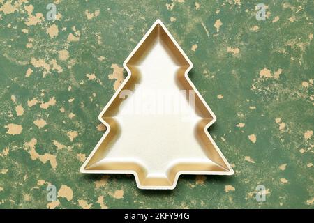 Plate in shape of Christmas tree on grunge background Stock Photo