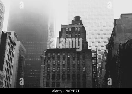 The old buildings of NYC, being overlooked by the grand architecture of the modern day. Out with the old, in with the new. Stock Photo