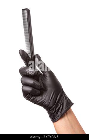 Hairdressers hand in black rubber glove holds a comb. Isolated on white background, close-up Stock Photo