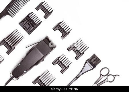 Professional hair clipper with set of nozzles of different sizes isolated on white background. Top view. Copy space for text Stock Photo