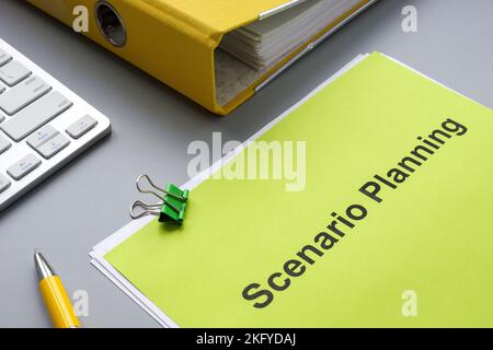 Scenario planning document near a yellow folder. Stock Photo