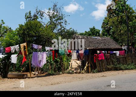 Malagasy people dry their clothes on a rock in Akamasoa village ...