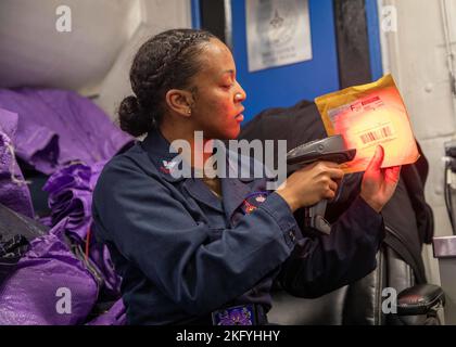 221015-N-IX644-2051 ADRIATIC SEA (Oct. 15, 2022) Logistics Specialist 2nd Class Makayla Johnson, from Prince George, Maryland, assigned to the Nimitz-class aircraft carrier USS George H.W. Bush (CVN 77), scans mail, Oct. 15, 2022. The George H.W. Bush Carrier Strike Group is on a scheduled deployment in the U.S. Naval Forces Europe area of operations, employed by U.S. Sixth Fleet to defend U.S., allied and partner interests. (This picture was blurred for security purposes) CONAC,CVN 77,GHWB,US Navy,USS George H. W. Bush (CVN 77), Stock Photo