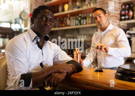 Visitor sitting in the bar Stock Photo