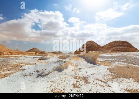 White desert bahariya egypt. White limestone rock formations and sand desert landscape. One off road car driving away on a trail. Scenic extreme Stock Photo