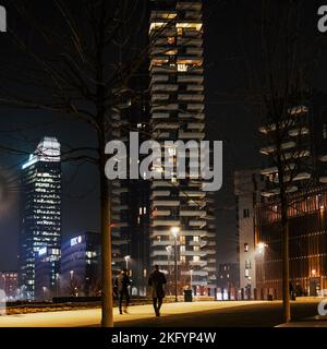 Night walk in a green area of Milan (Lombardy, Italy) known as BAM, the city's financial district park. In the foreground, the Solaria Tower building. Stock Photo