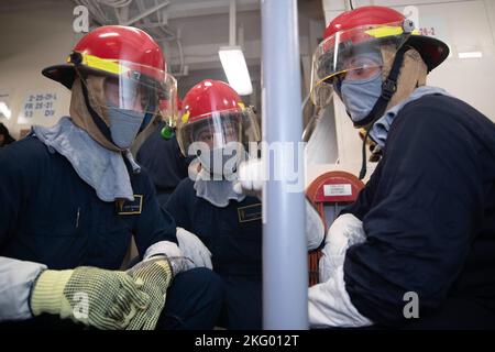 October 3, 2017) GROTON, Conn. – Yeoman Second Class David Baxter maneuvers  his bandit tool and cutter to complete half of a patch as Fireman Recruit  Anthony Lewis-Brannan holds the banding buckle.