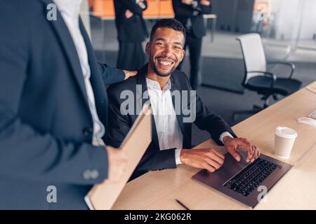 Two multiethnic colleagues working together on project in modern office Stock Photo