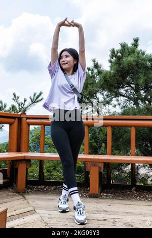 korean young women hiking and plogging stretching Stock Photo