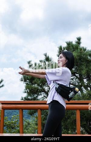 korean young women hiking and plogging stretching Stock Photo