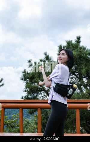 korean young women hiking and plogging stretching Stock Photo