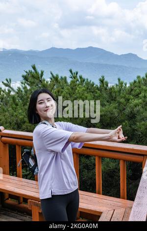 korean young women hiking and plogging stretching Stock Photo