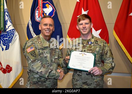 Sgt. John B. Hamilton, 1st Space Battalion, receives the Soldier's Medal, one of the Army’s most distinguished awards for heroism in a non-combat situation, from Lt. Gen. Daniel L. Karbler, commanding general, U.S. Army Space and Missile Defense Command, during a ceremony at Peterson Space Force Base, Colorado, Oct. 18. Stock Photo