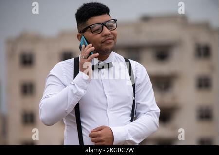Young man seen using his cellphone Stock Photo