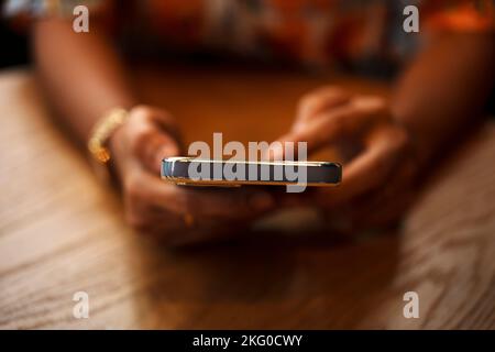 Close-up of woman's hand using a smartphone during coffee break. Stock Photo