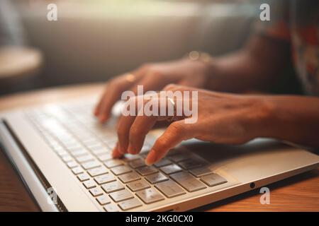Woman working on a laptop in a coffee shop. Stock Photo