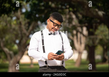 Young man seen using his cellphone Stock Photo