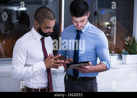 Late night management meeting. an office at night time. Stock Photo