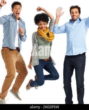 Positive smiles and joyful leaps. Group of casually dressed young adults jumping excitedly against a white background. Stock Photo