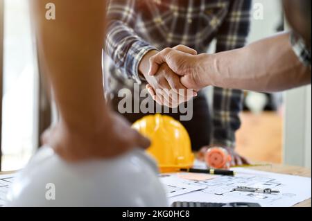 close-up hands image, Professional Asian male engineer shaking hands with male architect after the meeting. teamwork concept Stock Photo