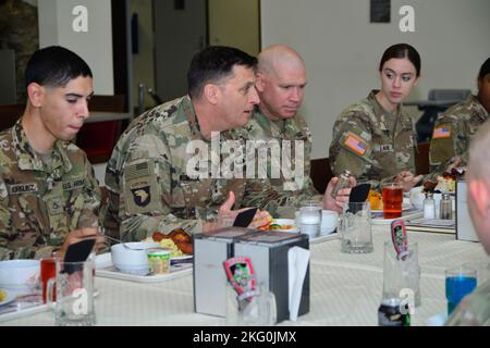 Command Sgt. Maj. Christopher Prosser, deputy command sergeant major forward, V Corps and Maj. Gen. David Womack, deputy commanding general-maneuver, had lunch with Soldiers assigned to the 12th Combat Aviation Brigade at the Katterbach Army Airfield, Germany, (date). 12 CAB is among other units assigned to V Corps, America's Forward Deployed Corps in Europe. They work alongside NATO Allies and regional security partners to provide combat-ready forces, execute joint and multinational training exercises, and retain command and control for all rotational and assigned units in the European Theate Stock Photo