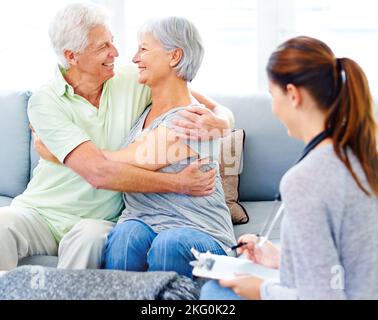 Its going to be okay now. A doctor explaining positive test results to an overjoyed senior patient and her husband. Stock Photo