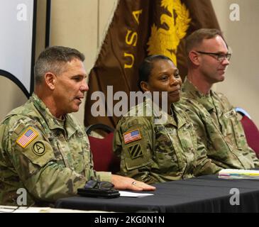 U.S. Army Reserve Chief warrant officer 5, Patrick Nelligan, command chief warrant officer, U.S. Army Reserve Command, left, speaks to an audience of current and retired warrant officers in Fayetteville, North Carolina., Oct. 20, 2022. Nelligan joined a panel of senior warrant officers, from all components of the Army, tackling issues facing the warrant officer cohort, recruiting and retention, and talent management. The annual meeting provides premier professional development panels every year, geared specifically for warrant officers. Stock Photo