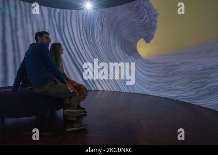 Adelaide, Australia. 21 November 2022.  Visitors take part in an immersive 360-degree installation  from sea to sky created by Gerry Wedd which unites digital imagery, ceramics and sound and offers a powerful commentary about the human impact upon the natural world,. Credit: amer ghazzal/Alamy Live News Stock Photo