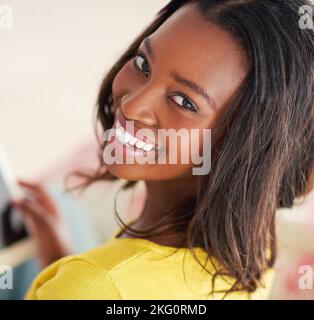 Just me and my tablet. Portrait of an attractive young woman using a digital tablet relaxing at home. Stock Photo